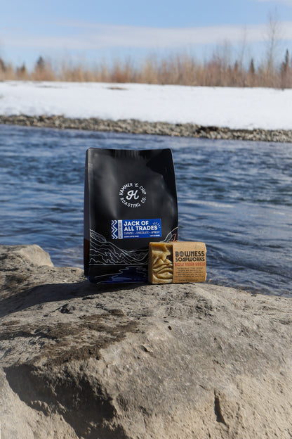 A bag of coffee besides a bar of soap.